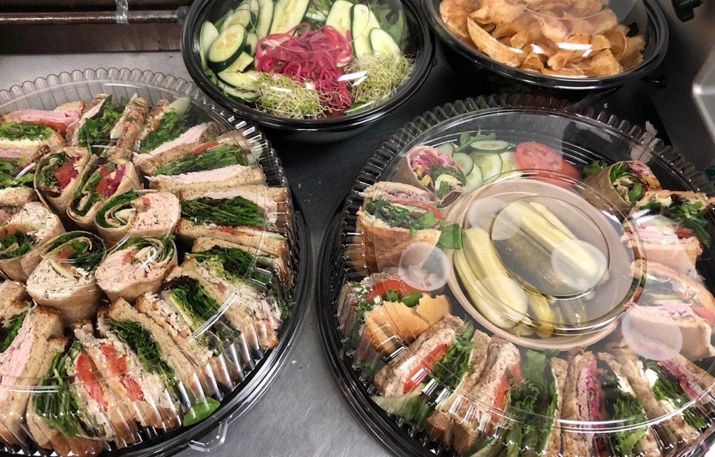 Real MBB catering platters — sandwich rolls, salad and chip trays